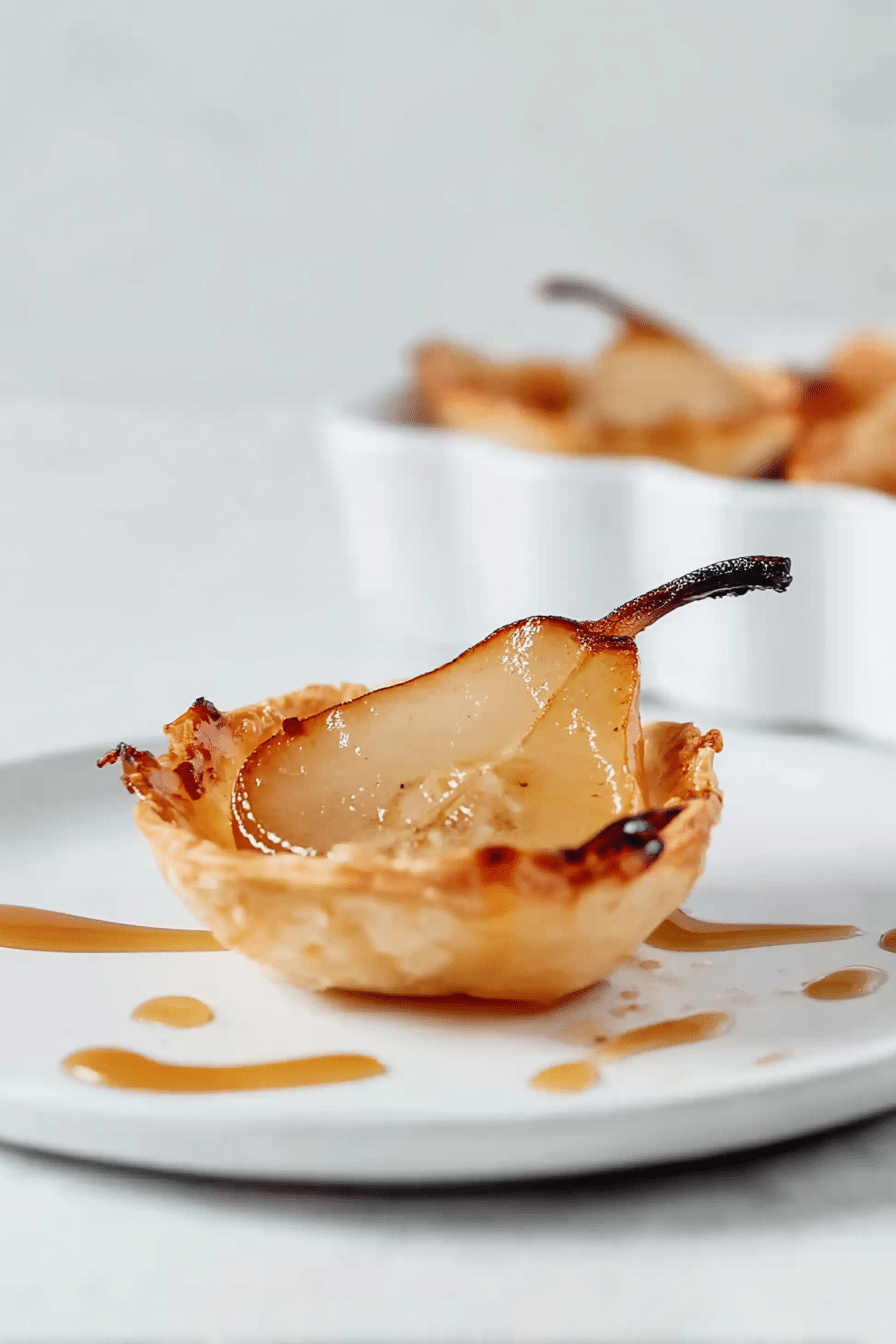Air fryer pear tart with caramel drizzle on white plate
