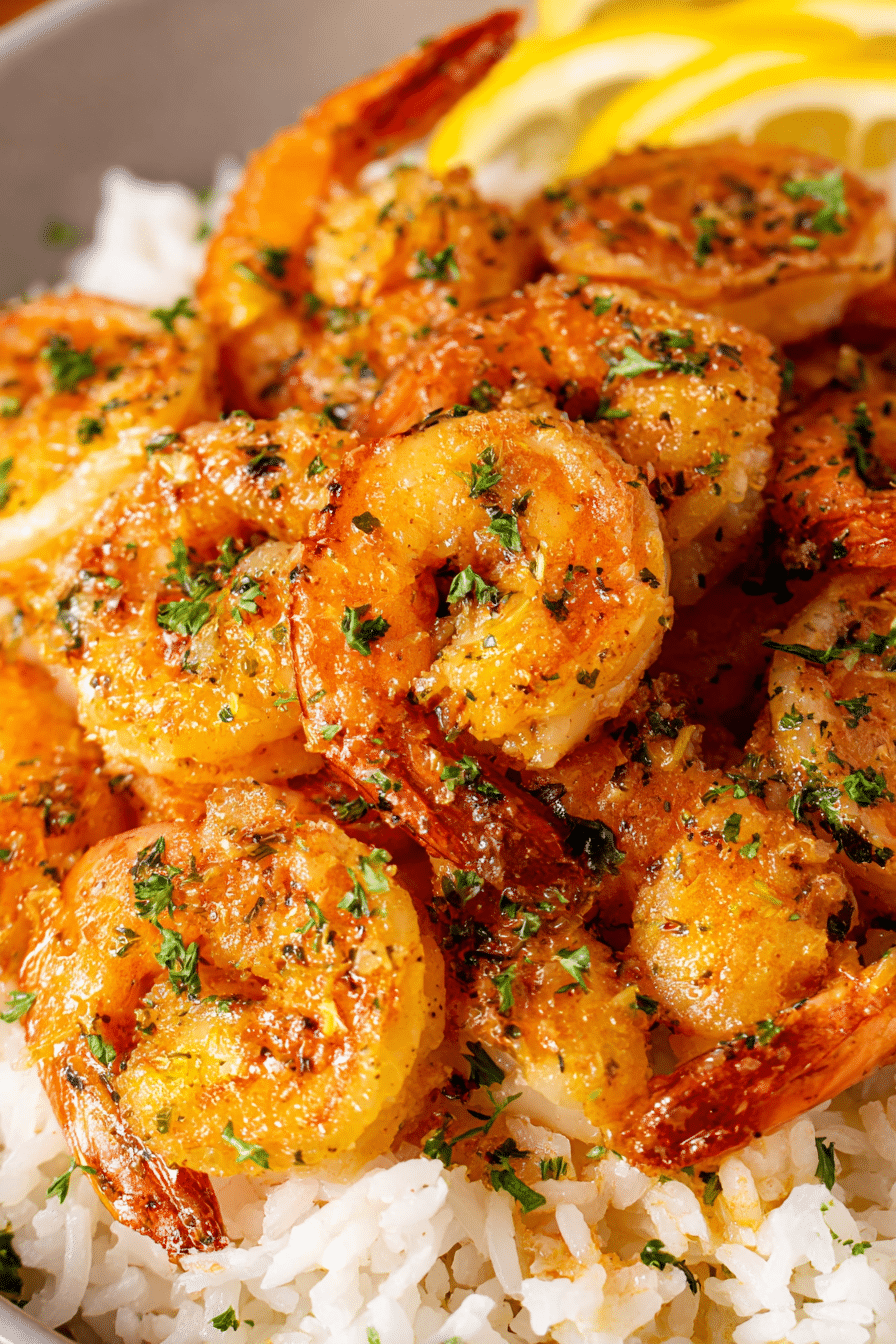 Garlic butter air fryer shrimp served over white rice with lemon slices